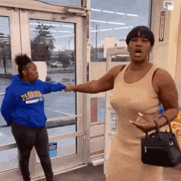 a woman wearing a blue hoodie that says florida on it is standing next to another woman