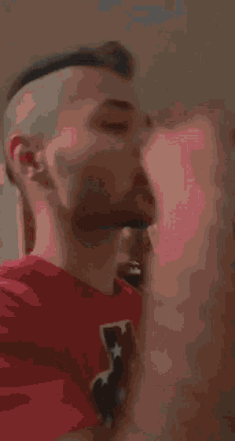 a man with a beard is drinking from a box