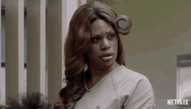 a woman with curlers in her hair and a netflix logo on the bottom