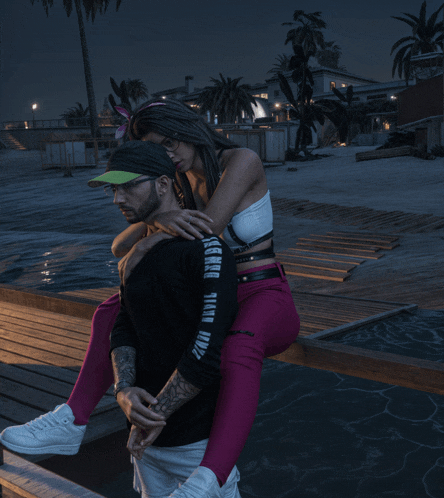 a man is carrying a woman on his back who is wearing a shirt that says third wave on it
