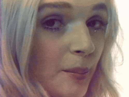 a close up of a woman 's face with a tear running down her cheek