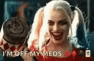 harley quinn from the movie suicide squad is smiling and holding a cigarette .