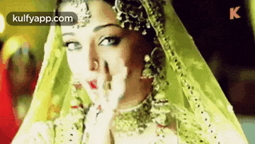 a close up of a woman wearing a veil and earrings .