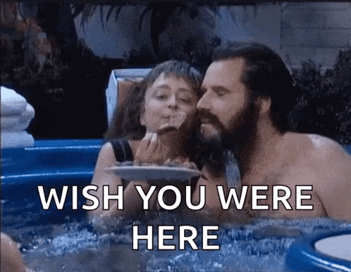 a man and a woman in a hot tub with the words wish you were here on the bottom