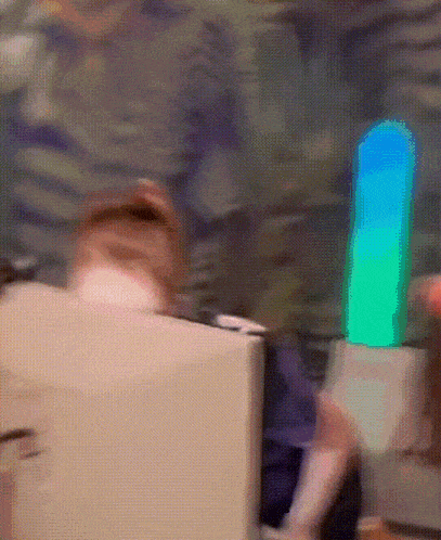 a blurred image of a person sitting in front of a computer