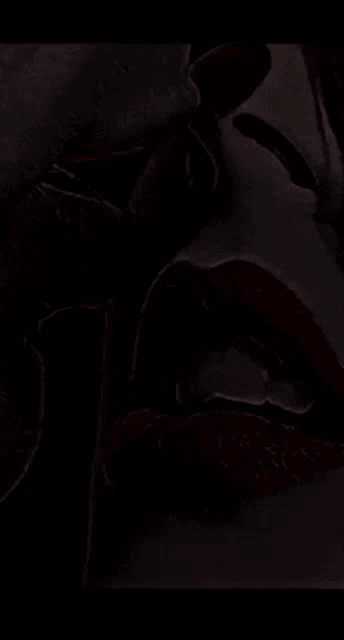 a close up of a woman 's red lips with a purple background