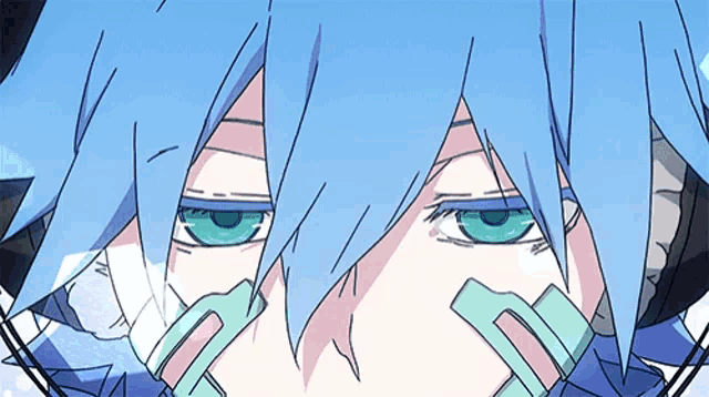a close up of a person 's eyes with blue hair