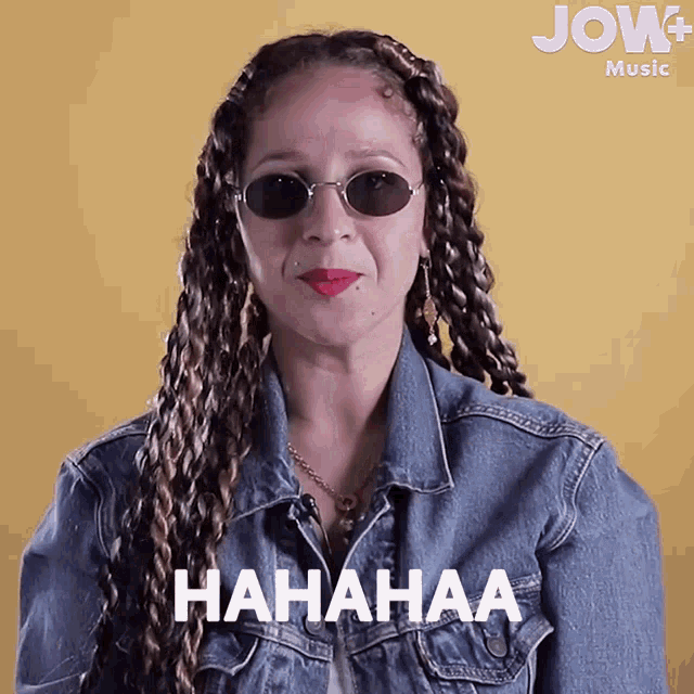 a woman wearing sunglasses and a denim jacket says '  hahahaa '
