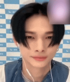 a close up of a person 's face with a checkered background behind them