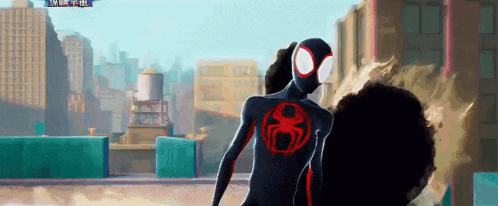 a man in a black suit with a red spider on his chest is standing in front of a city skyline .