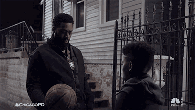 a man holding a basketball in front of a house with #chicagopd