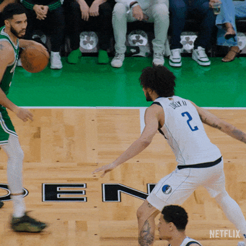 a basketball game is being played on a court that has the letter n on it