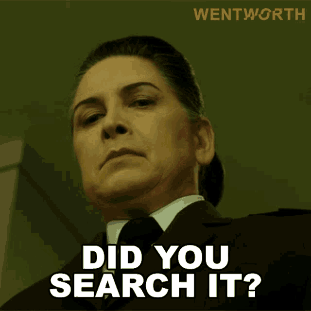 a woman in a suit and tie is asking if she did you search it