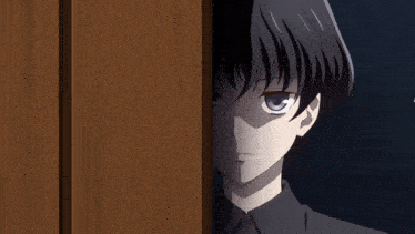 a boy with black hair is peeking out from behind a wooden wall