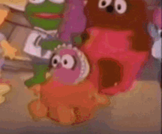 a blurry picture of sesame street characters including a frog