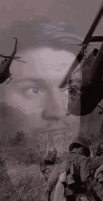a helicopter is flying over a soldier 's face in a field