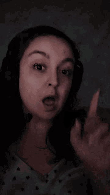 a woman wearing headphones is pointing up with the words booopers written below her