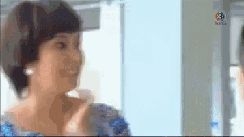 a blurry picture of a woman looking at herself in a mirror ..