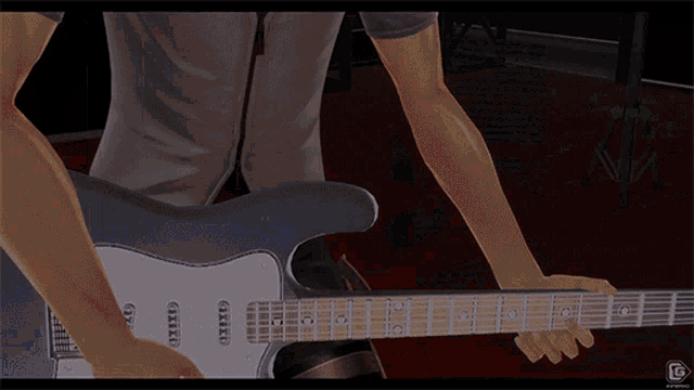 a man is playing a guitar with a g on the bottom of the screen