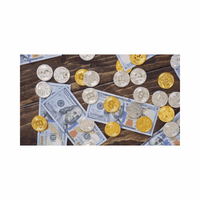 a pile of 100 dollar bills and coins on a wood table
