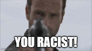 a man is holding a gun and says `` you racist ! ''