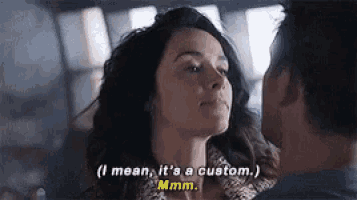 a man and a woman are looking at each other and the woman says i mean it 's a custom