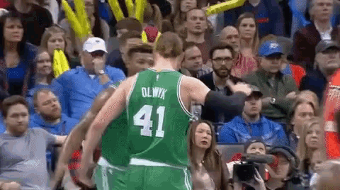 a basketball player wearing a green uniform with the number 41 on it