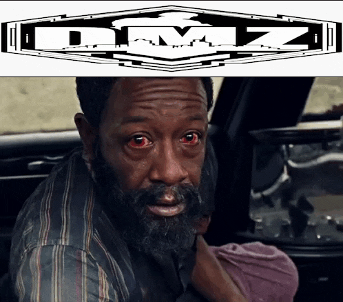 a man with a beard and red eyes is next to a logo for dmz