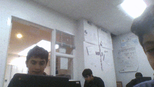 a group of people are sitting in front of a wall that says world