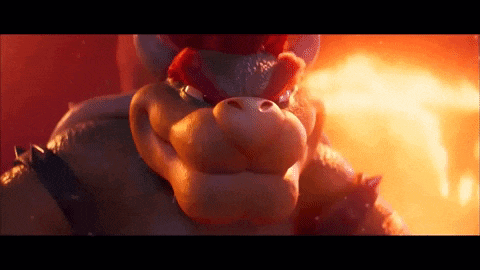 a close up of bowser 's face in front of a fireball .