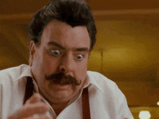 a man with a mustache is making a funny face