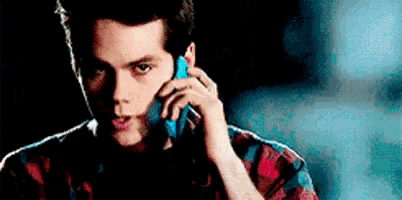 a man is talking on a cell phone in the dark .