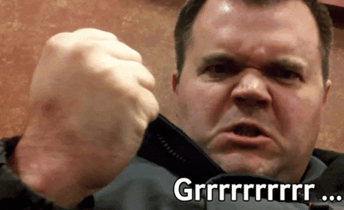 a man is making a funny face with the words grrr on the bottom of his face