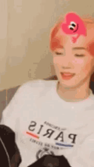 a woman with red hair is sitting on a couch with her eyes closed .