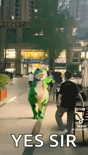 a person in a frog costume is walking down a street .