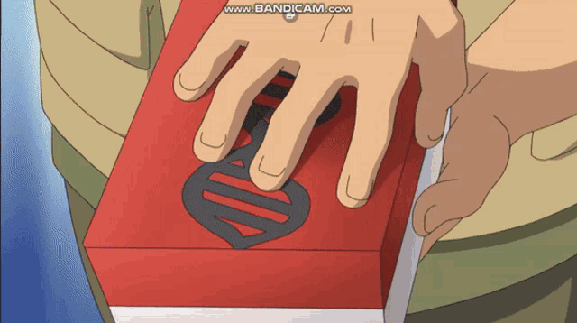 a person is holding a red box with the word bandcam on the bottom right