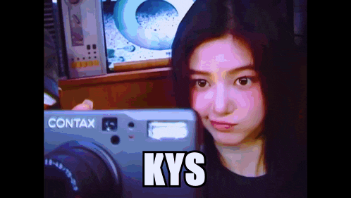 a woman is looking at a contax camera and says kys