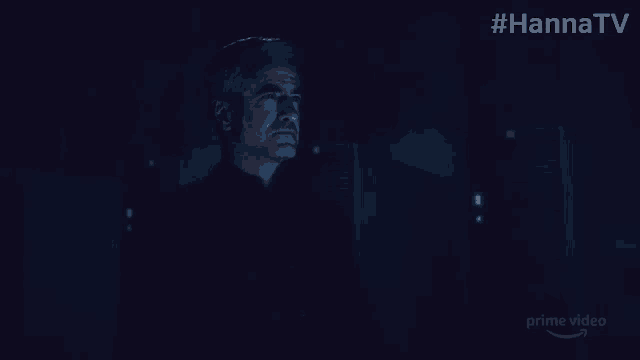 a man stands in a dark room with #hannatv written on the bottom