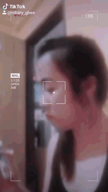 a woman 's face is being recorded by a tiktok camera