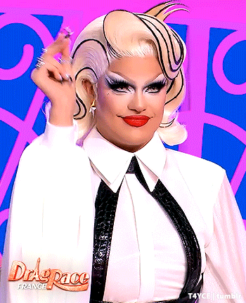 a drag queen is wearing a white shirt and black tie with the words drag race france on the bottom