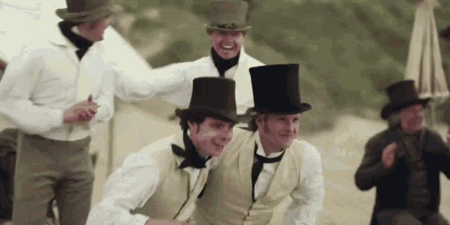 a group of men wearing top hats and vests are posing for a photo