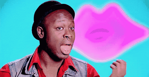 a man wearing a hat and a red shirt is making a funny face in front of a pink lips .