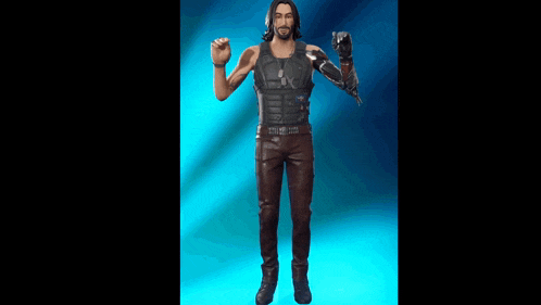 a man with long hair and a beard is standing in front of a blue background and holding a gun .