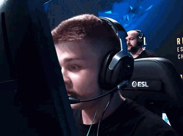 a man wearing a headset that says esl on the front