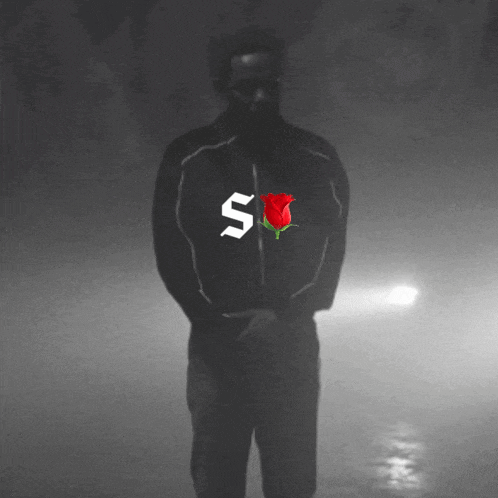 a man with the letter s on his jacket and a rose