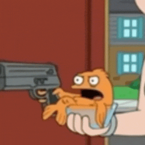 a person is holding a cartoon character in their hand and pointing a gun .