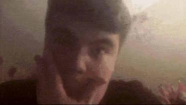 a close up of a person 's face with their hand on their face