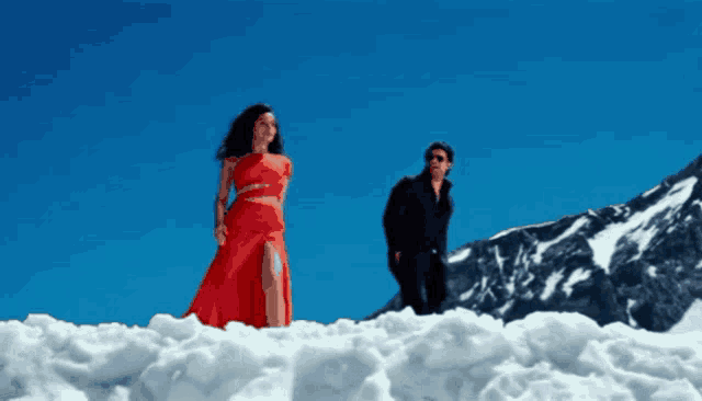 a man and a woman standing in the snow