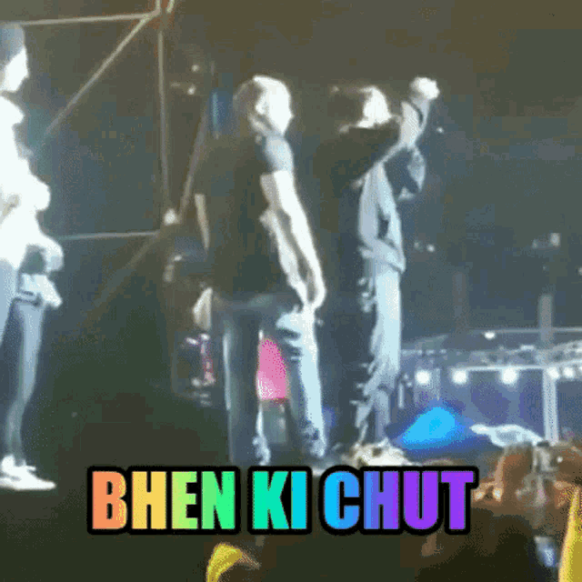 a group of people standing on a stage with the words bhen ki chut on the bottom right