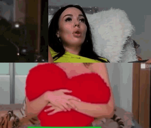 a woman is holding a heart shaped pillow in her arms .